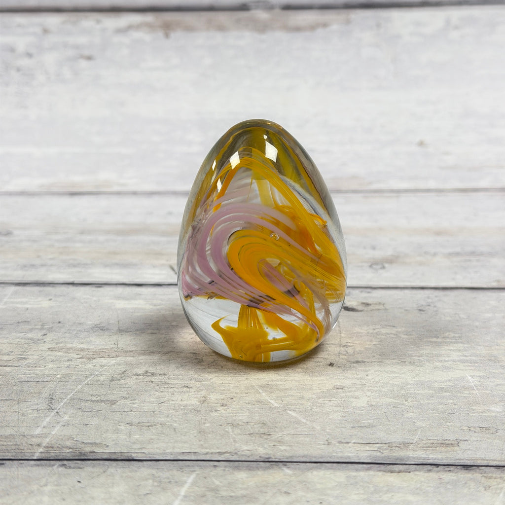 Reverse view of yellow and pink swirl art glass egg paperweight