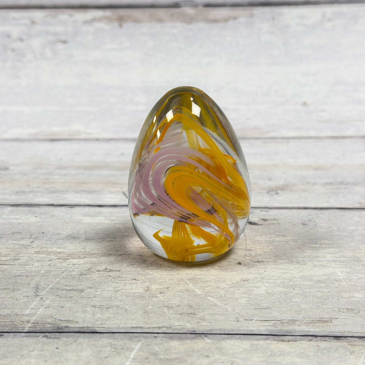 Reverse view of yellow and pink swirl art glass egg paperweight