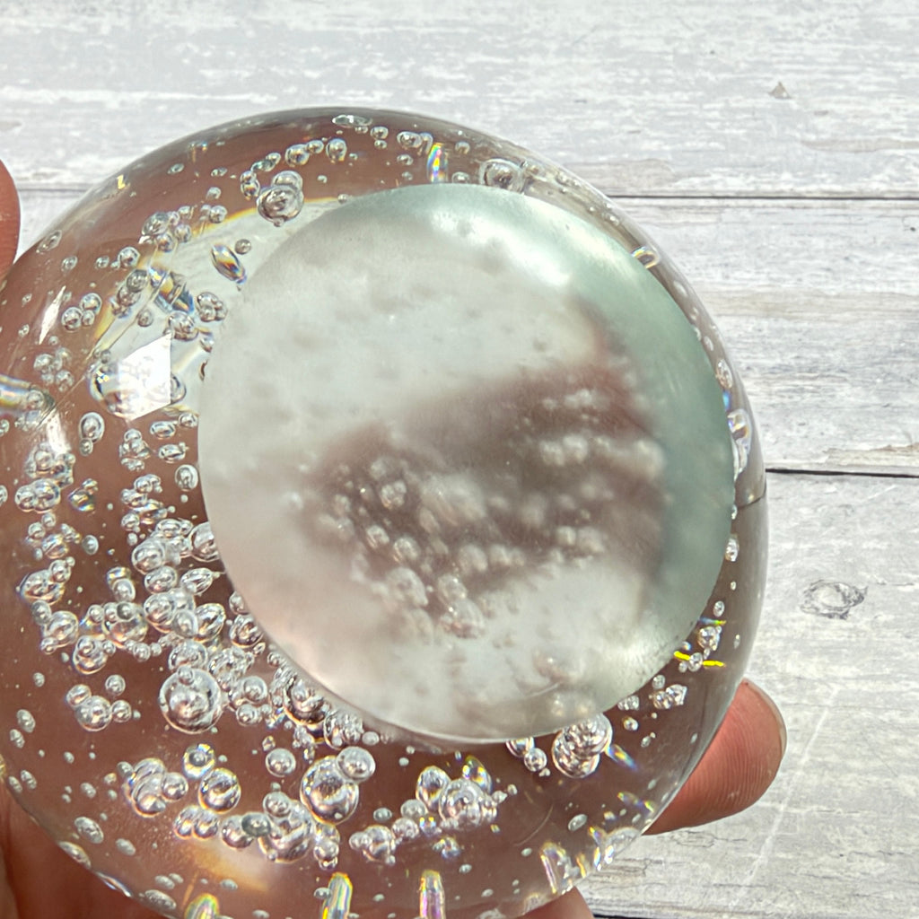 Unmarked ground base of clear bubble glass paperweight