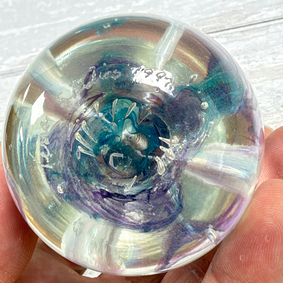 Polished paperweight base showing the engraved date and light underside wear