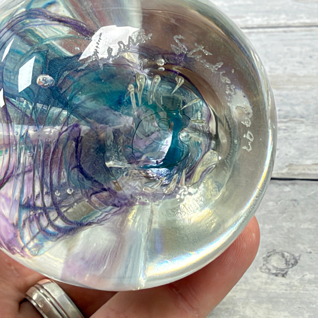 Underside of the paperweight showing the engraved studio signature attributed to Glass Eye Studio