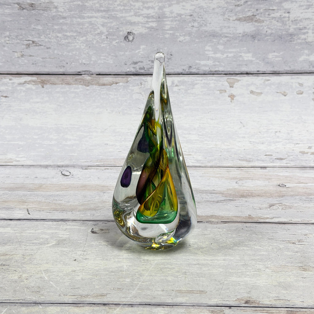 Green, yellow and purple ribbon crystal paperweight in an elongated teardrop shape