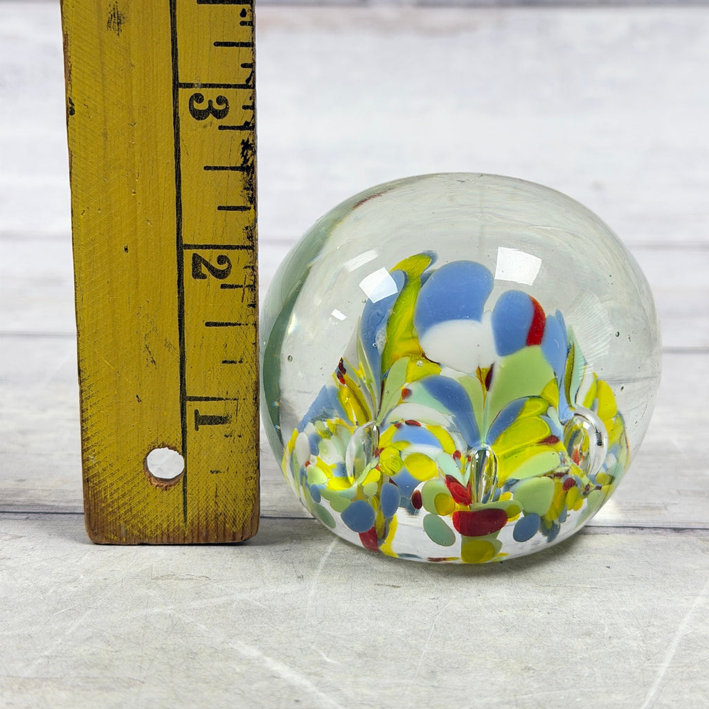 Multicolor confetti glass paperweight beside a ruler showing an approximate two-and-a-half-inch height