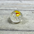 Mini clear glass paperweight with a yellow butterfly, red body, black antennae and controlled bubbles