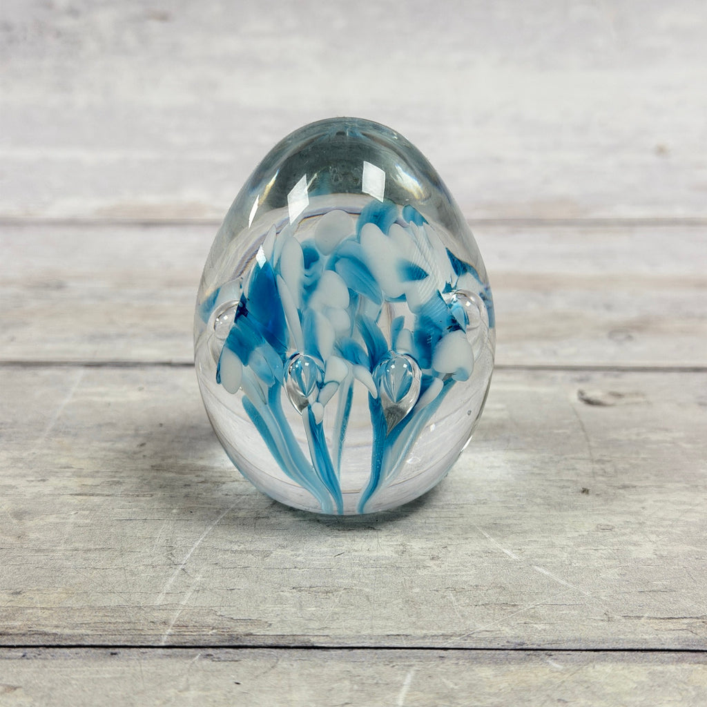 Gibson 1995 egg-shaped glass paperweight with blue and white floral swirls and controlled bubbles