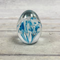 Gibson 1995 egg-shaped glass paperweight with blue and white floral swirls and controlled bubbles
