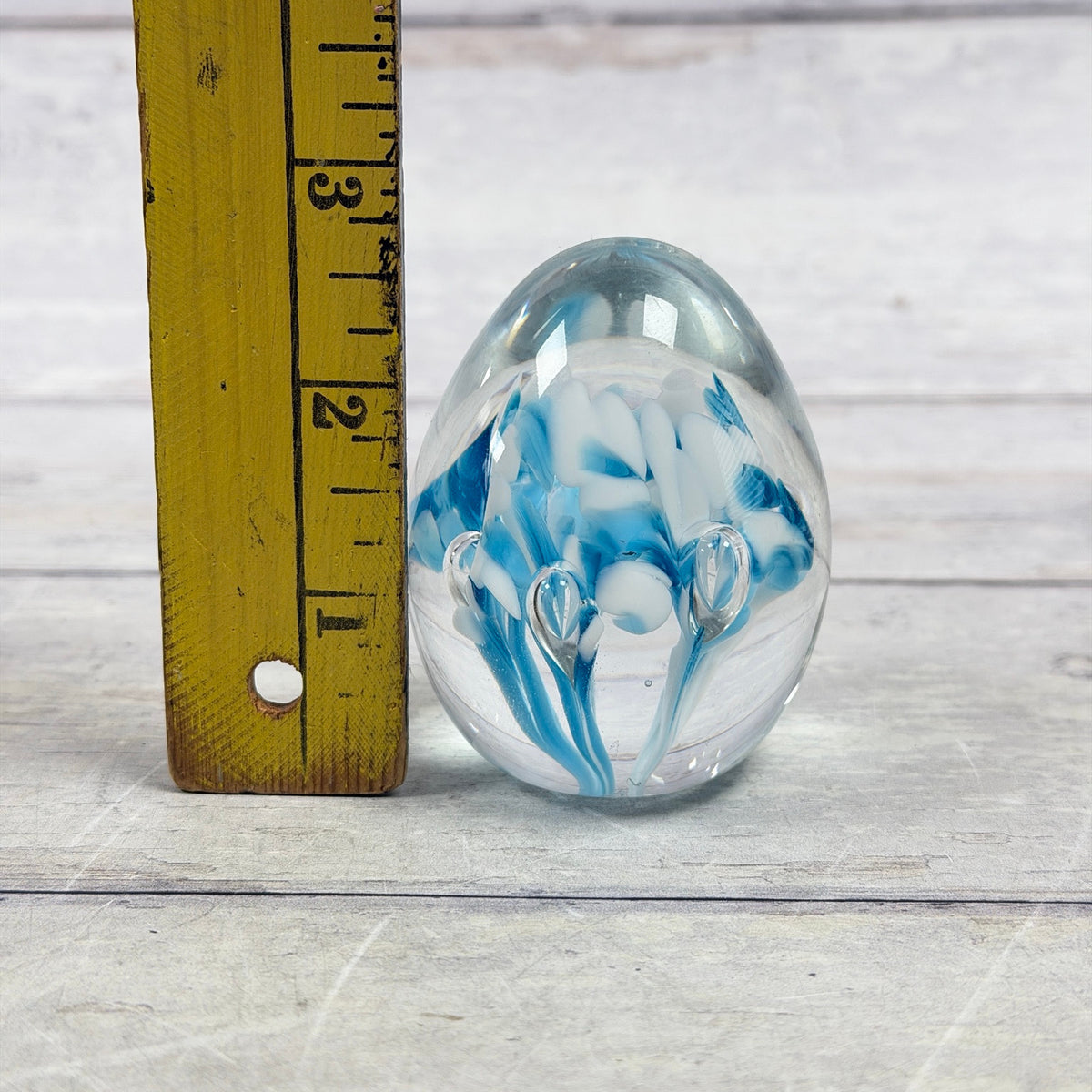 Gibson blue and white egg paperweight beside a ruler showing an approximate two-and-three-quarter-inch height