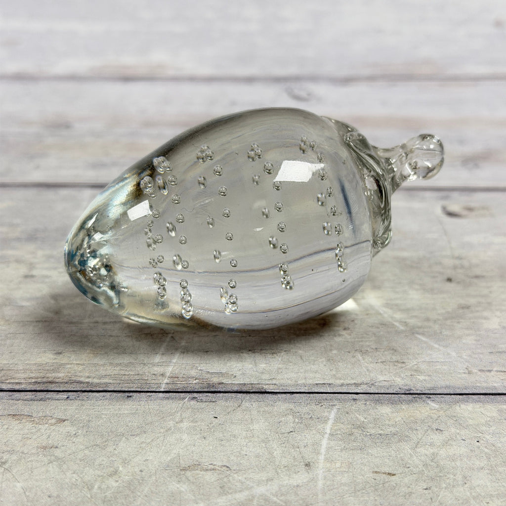 Clear strawberry-shaped glass paperweight with controlled bubbles
