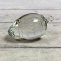 Clear strawberry-shaped glass paperweight with controlled bubbles