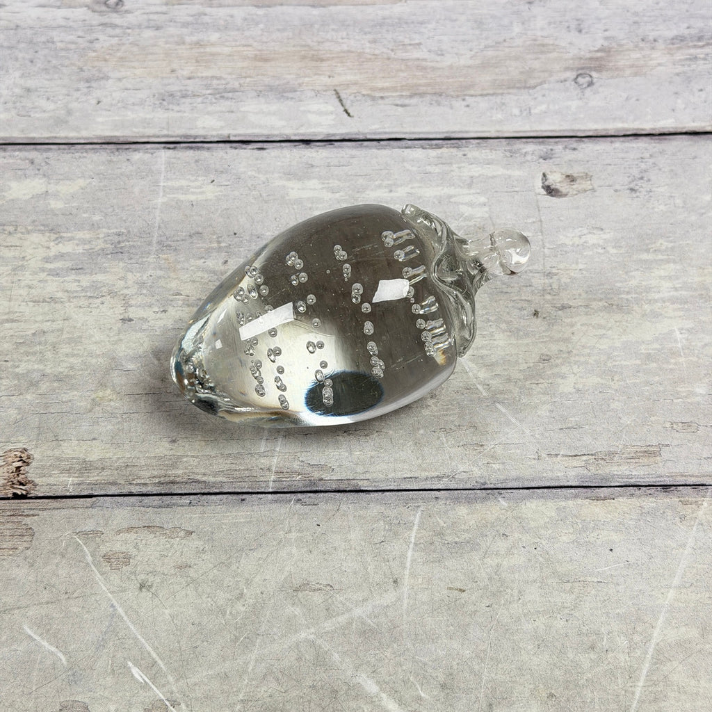 Clear strawberry-shaped glass paperweight with controlled bubbles
