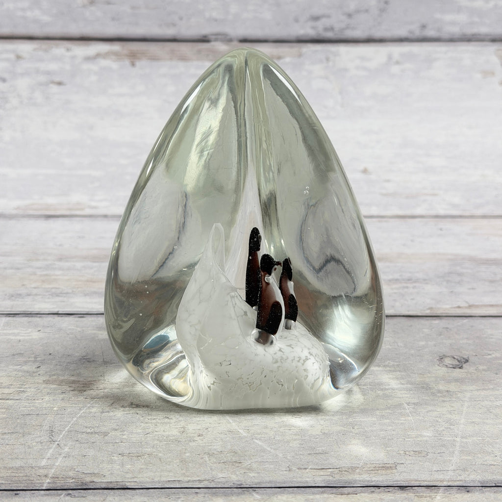 Reverse view of clear penguin scene glass paperweight