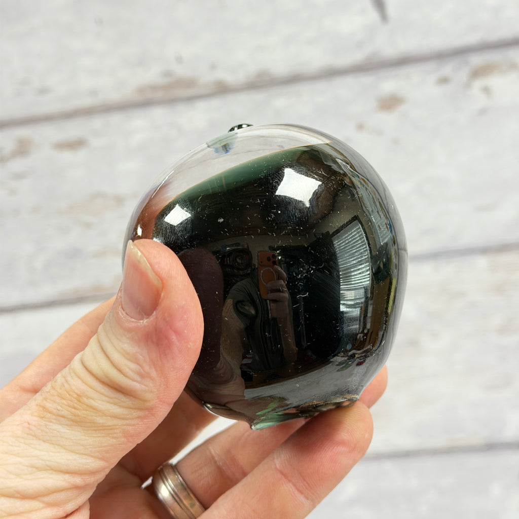 Dark Green Glass Apple Paperweight, close-up of surface or underside; display props not included