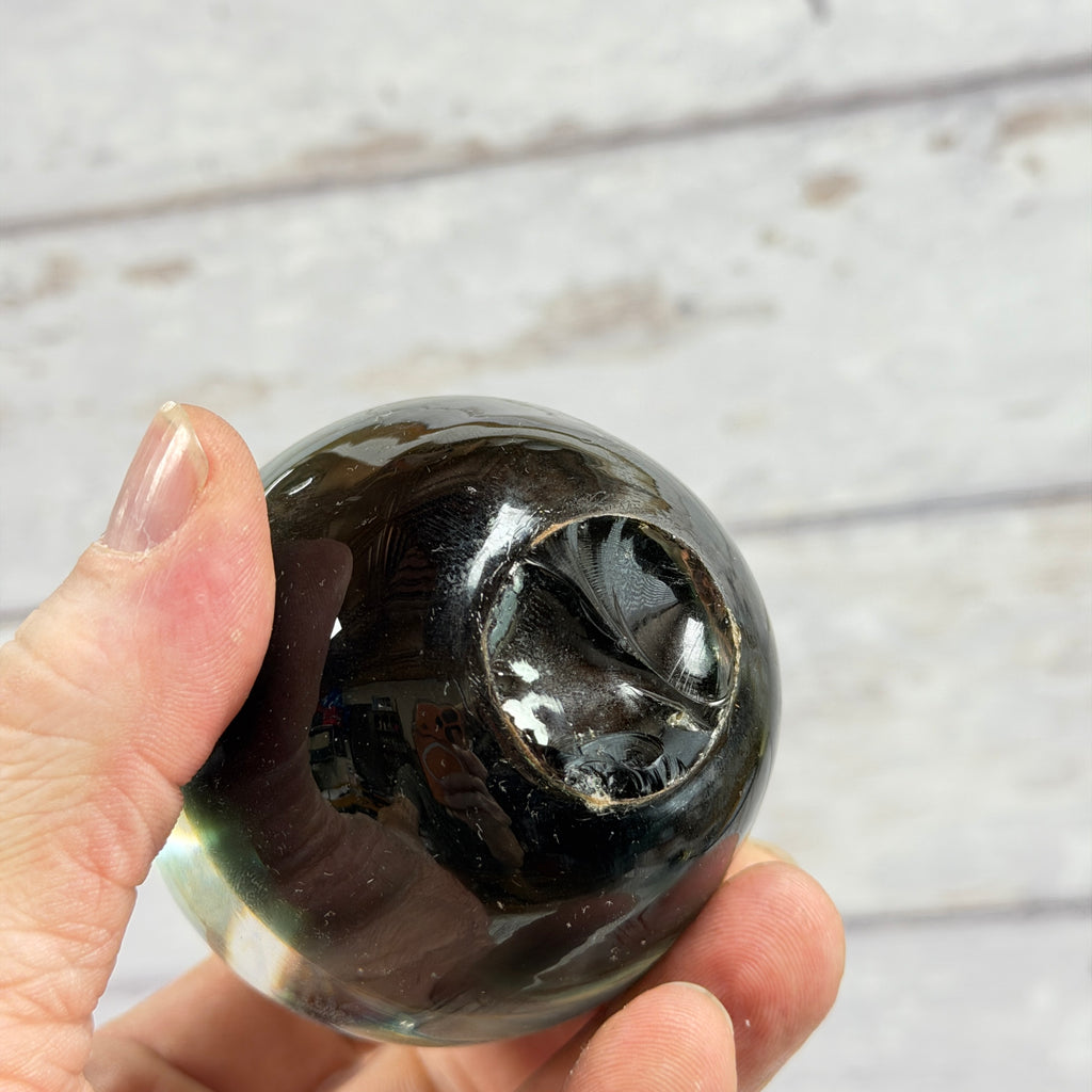 Dark Green Glass Apple Paperweight, close-up of surface or underside; display props not included