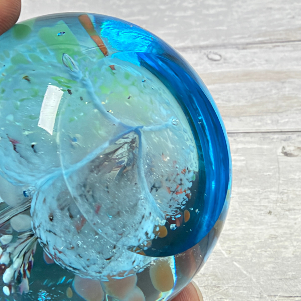 Aqua Blue Controlled-Bubble Glass Paperweight with Multicolor Frit - underside detail