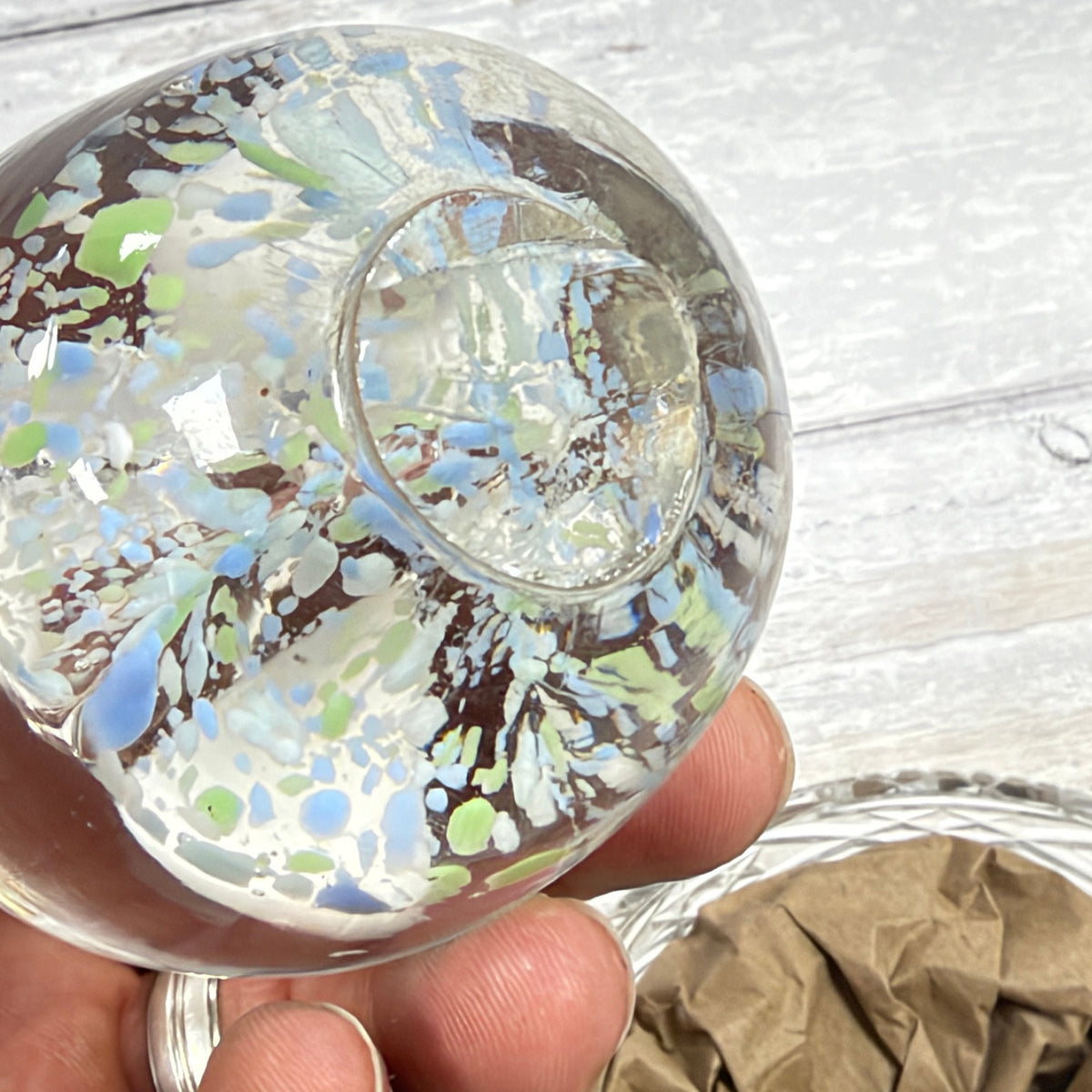 White trumpet-flower glass paperweight underside with visible circular base finishing area and fine lines